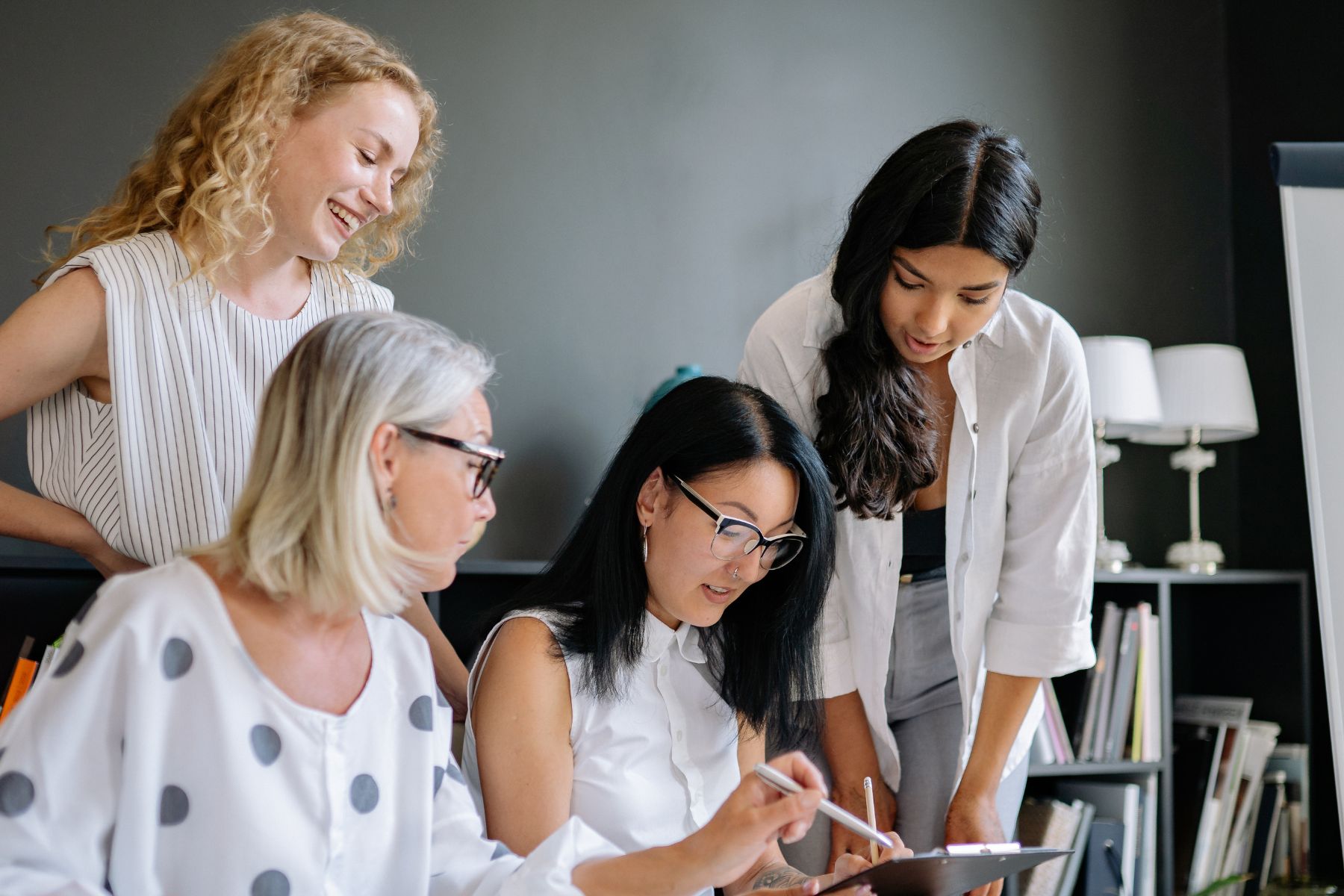 four women working together